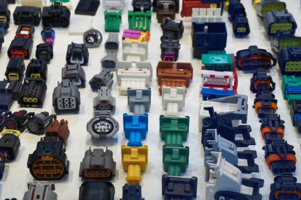 Assorted automotive electrical connectors displayed in rows.