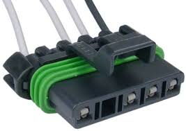 Four-pin electrical connector with secured green wires.