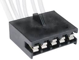 Black plastic electrical connector with multiple pins and a cable harness attached.