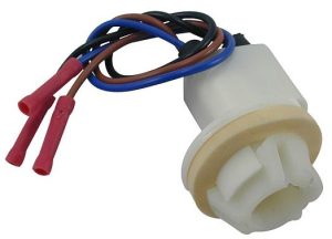 Plastic fuel pump component with attached wiring and connectors.
