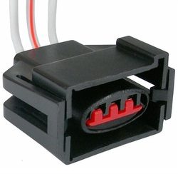 A black plastic electrical connector with red terminals and attached wires.