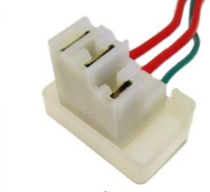 Plastic electrical connector with red, black, and green wires.