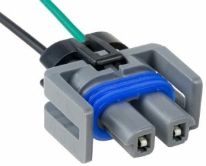 A gray and blue connector is connected to an electrical wire.
