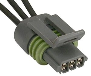 A gray connector with three wires attached to it.