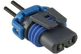 A blue and gray connector is connected to wires.