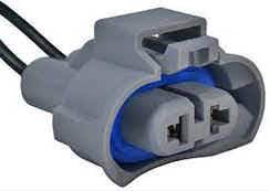 A gray and blue connector is connected to the wires.