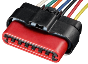A red and black connector with wires attached to it.