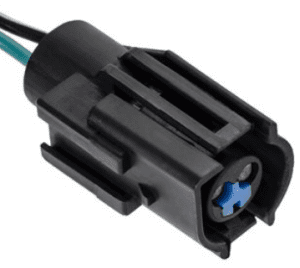 A black connector with blue wire and green cable.