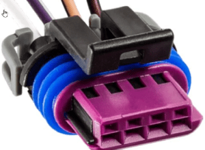 A purple and blue connector is connected to wires.