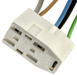 A white electrical connector with wires around it.