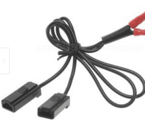 A red and black cable is connected to two wires