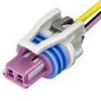 A purple and white connector with wires attached.
