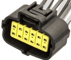 A close up of the yellow connector on a car.